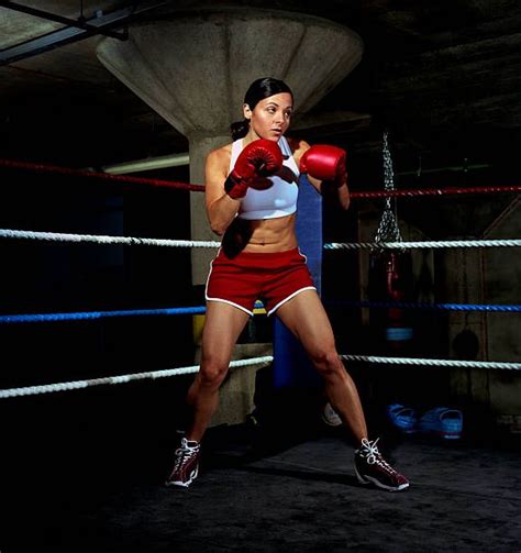 Young Female Boxer In Ring Gloves Raised Portrait Boxing Stance