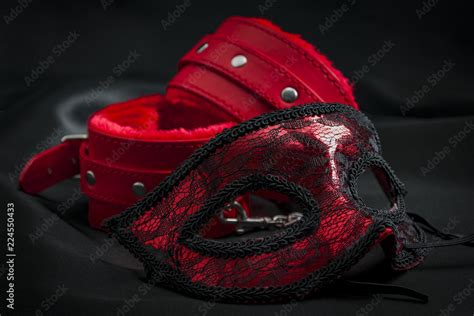 bdsm bondage play fetish wear and kinky sex toy concept with close up on erotic mask and red