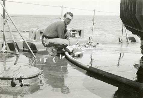 Unidentified Barefoot Sailor Cleaning The Deck Of The Uss Rutland In