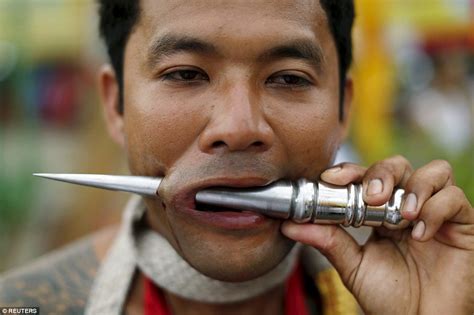 Thai Men Force Sharp Spikes Through Their Cheeks As They Celebrate