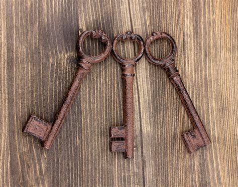 Premium Photo Three Antique Keys On Wooden Background