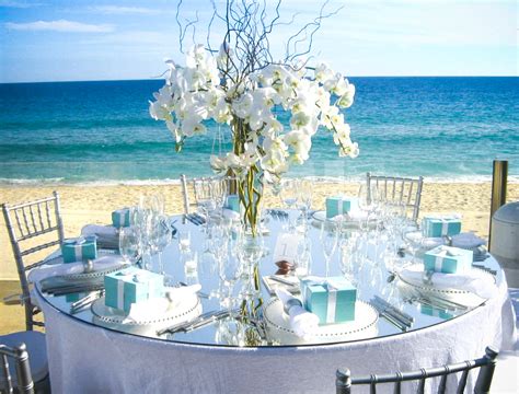 Wedding reception table with centerpieces for a beach reception in tropical nassau bahamas decorated table reception at beach resort. beach | "i do", they vowed