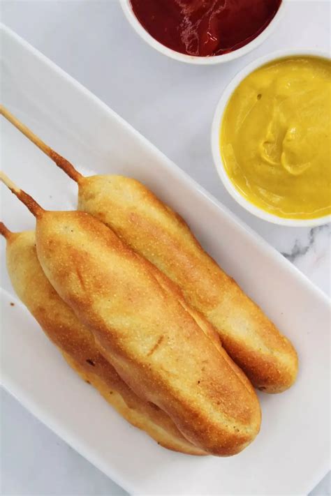 Two Skewers On A Plate With Dipping Sauces