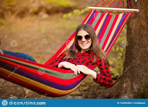 carefree-happy-woman-lying-on-hammock-enjoying-harmony-with-nature