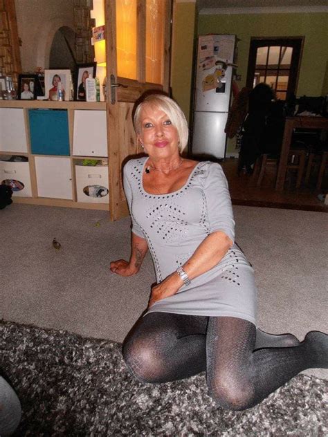 An Older Woman Sitting On The Floor In Her Living Room