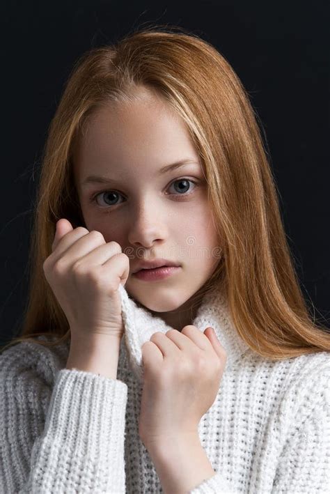 Close Up Portrait Of Beautiful Young Redhead In Studio On Beige