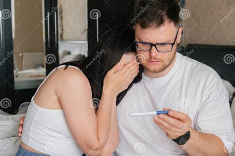 Worried Couple Looking At Positive Pregnancy Test Stock Photo Image