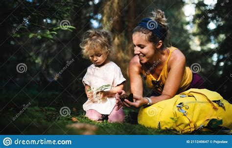 Happy Mother With Small Daughter Outdoors In Summer Nature Resting In Forest Stock Image
