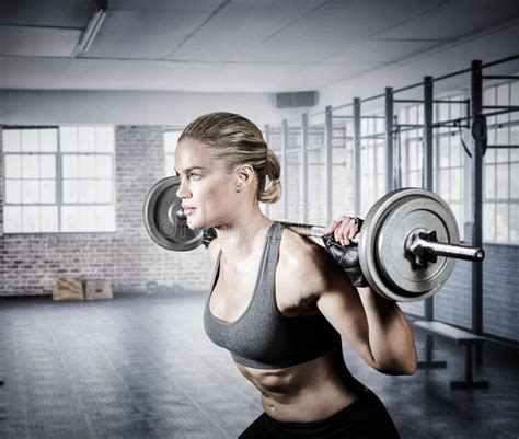 Composite Image Of Muscular Woman Lifting Heavy Barbell Stock Photo