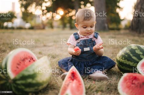 Cute Little Baby Girl Laughing With Watermelons Girl Dressed In Denim
