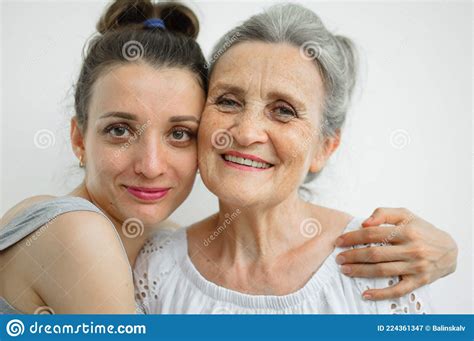 Happy Senior Mother Is Hugging Her Adult Daughter The Women Are Laughing Together Sincere