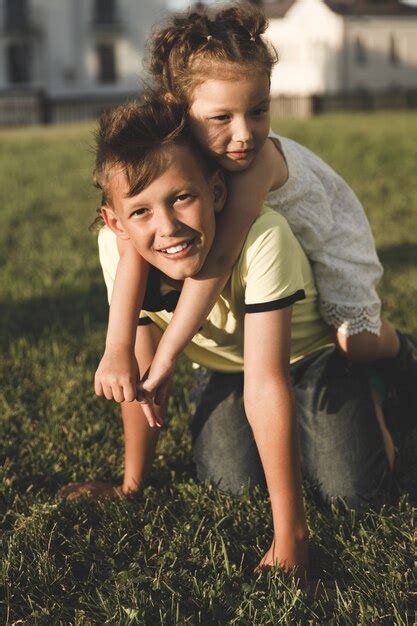 premium photo brother and sister play outdoors in summer close up portraits vertical frame