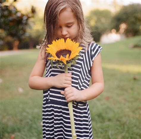 Cute Young Girl With A Big Sunflower By Jakob Lagerstedt