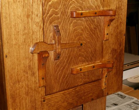 Twelve cabinet doors needed to be made to match the desired rough sawn theme. Rustic Wall Cabinet w/Hand Carved Hinges & Latch | Max Vollmer