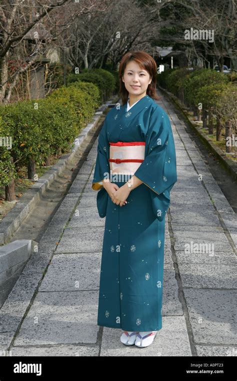 Full Length Beautiful Japanese Woman Wearing Traditional Kimono Poses
