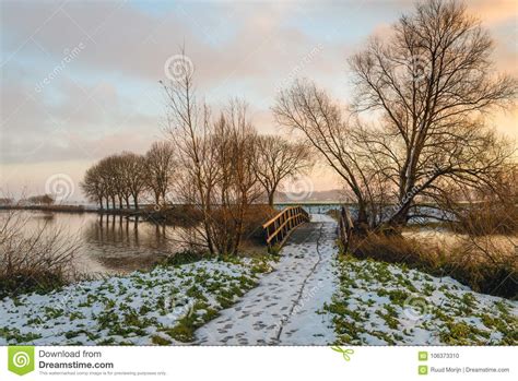 Picturesque Landscape With A Wooden Footbridge In Winter Stock Photo