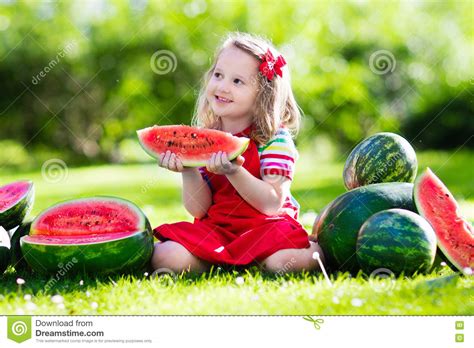 Little Girl Eating Watermelon In The Garden Stock Image