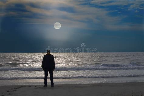 Man Stands On A Lonely Beach At Moonrise Stock Image Image Of Alone