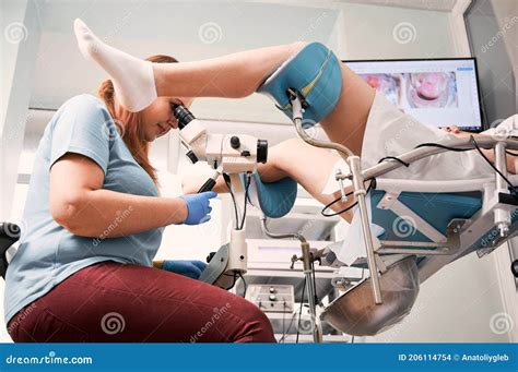 Gynecologist Examining Female Patient With Colposcope Stock Photo