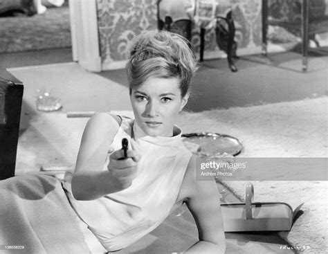 Daniela Bianchi Lying On Her Side Pointing A Gun In A Scene From The