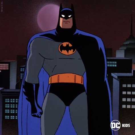 Batman Standing In Front Of The City At Night With His Cape Open And