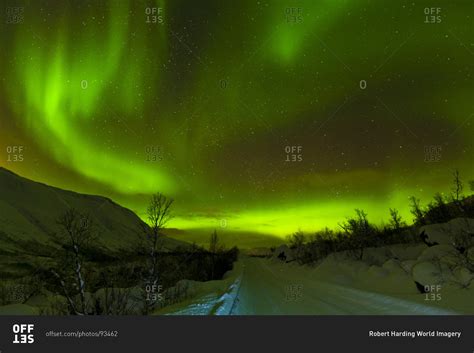 Aurora Borealis Northern Lights Seen Over A Snow Covered Road Troms