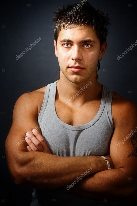 Handsome Muscular Man With Arms Folded — Stock Photo © Dundanim 9921078