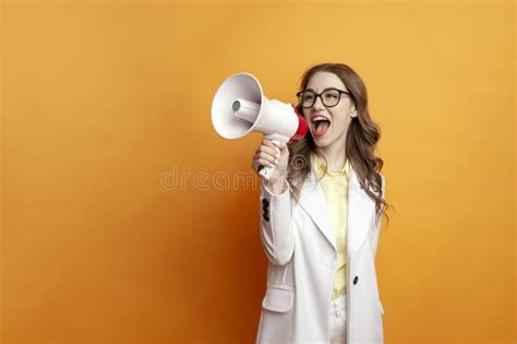 Business Girl In Glasses And Suit Announces Information Into Megaphone