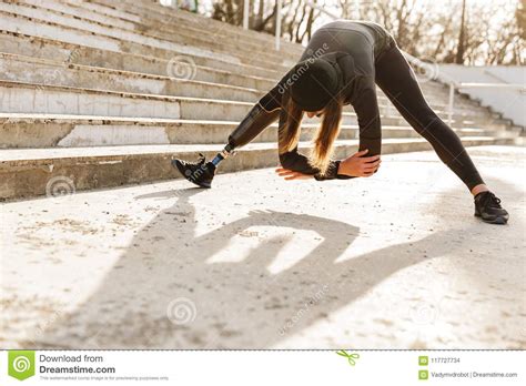 Image Of Disabled Sportswoman In Black Tracksuit Having Prosthetic Leg