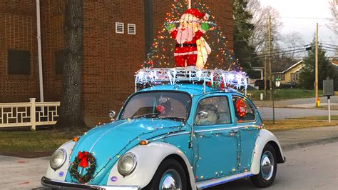 Vintage Vw Beetle Spreads Holiday Cheer With Strings Of Lights And