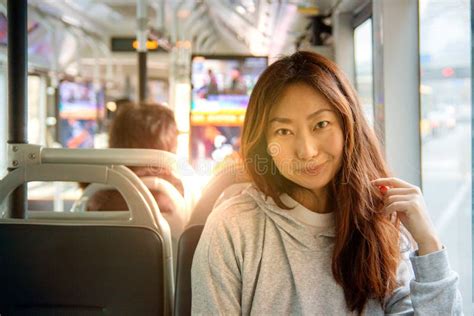 Young Pretty Asian Woman Traveling By Train Or Bus Sitting Near The