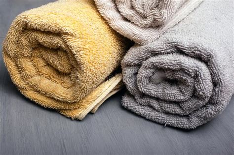 Multi colors bath towel are used to dry hands, either at home or in spas and hotels. Multi-colored Bath Towels On A Gray Background. Beauty ...