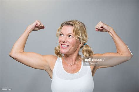 Smiling Older Woman Flexing Biceps High Res Stock Photo Getty Images