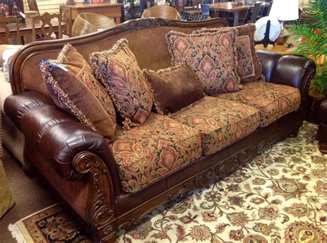 Leather and fabric sofa with wood trim and throw pillows. $549.95