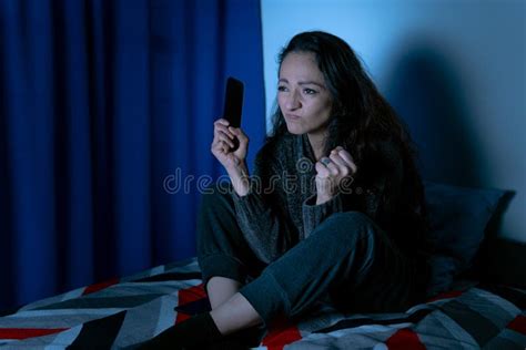 Depressed Woman Sitting Up In Bed Unable To Sleep From Insomnia Stock