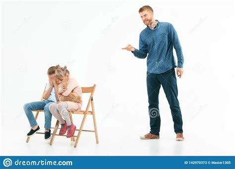 Angry Father Scolding His Son In Living Room At Home Stock Image