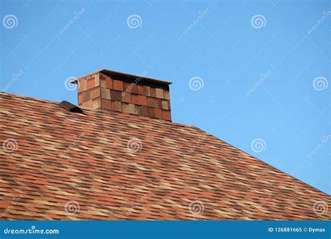 Brown Roof Of A House Covered With Soft Shingles With Short Big