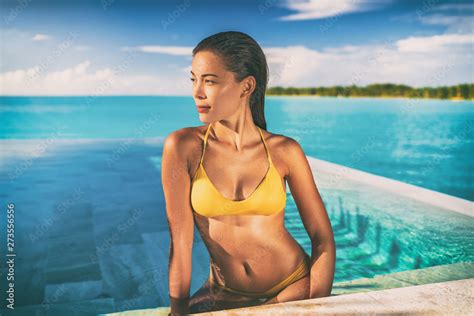 Sexy Asian Bikini Model Woman Sun Tanning In Infinity Pool At Luxury Hotel In Bora Bora Tahiti
