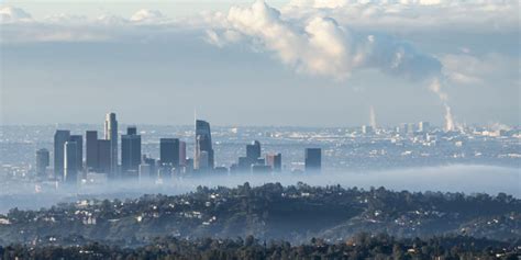 Foggy Morning Skyline View Of Downtown Los Angeles With Steaming Scope
