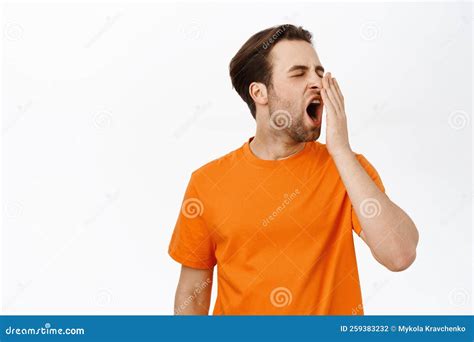 Bored Or Tired Adult Man Yawning Cover His Opened Mouth With Hand