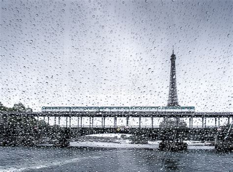 Closeup Shot Of A Window With Rain Droplets And The Eiffel Tower In The