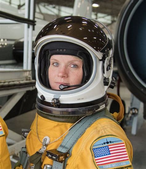 A Woman In A Space Suit With An American Flag On The Side Of Her Face
