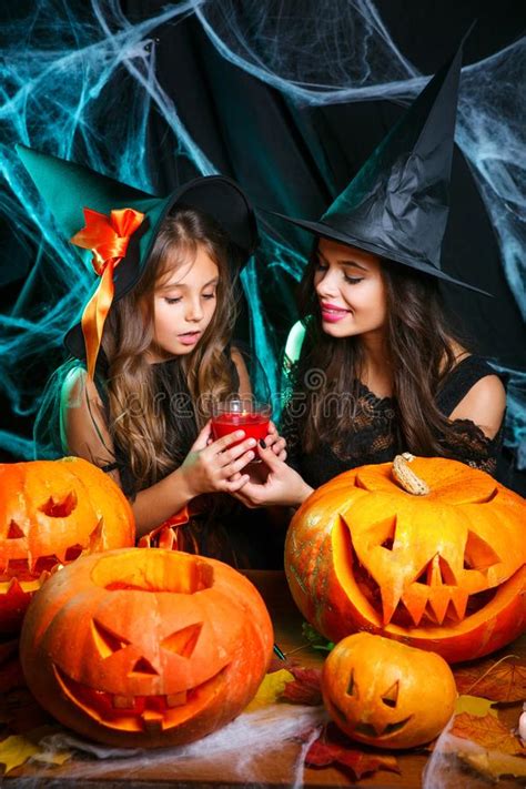 halloween concept closeup beautiful caucasian mother and her daughter in witch costumes