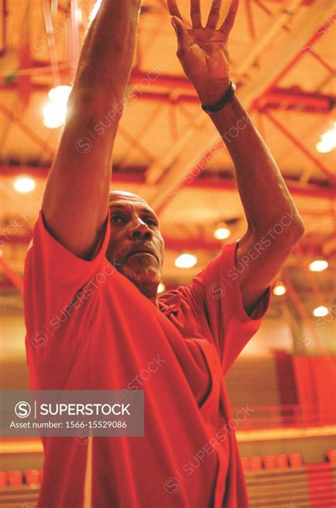 Black Male Model Poses For Pictures With A Basketball Superstock