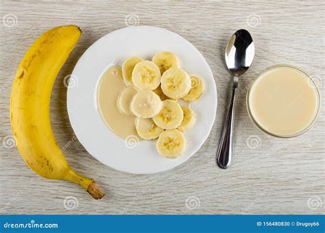 Whole Banana White Plate With Slices Of Banana And Condensed Milk