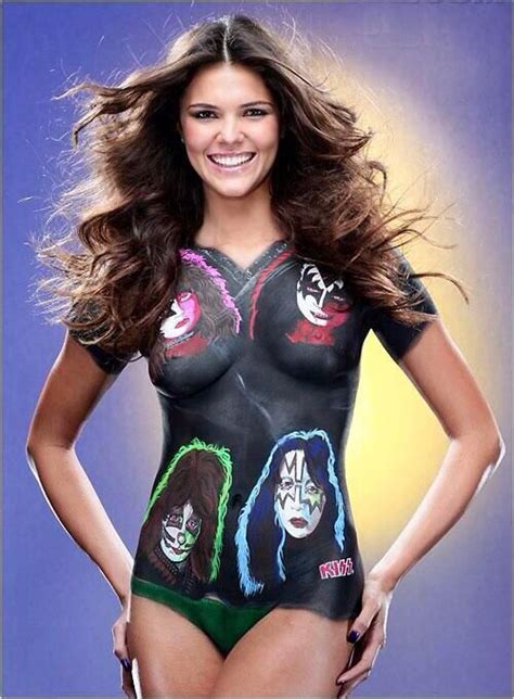 A Woman In A Bodysuit With Many Faces On It