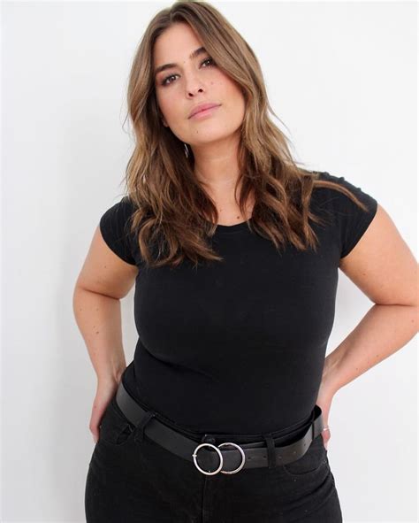 A Woman With Her Hands On Her Hips Posing For The Camera While Wearing