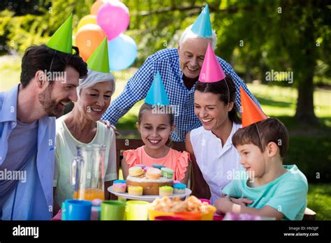 Happy Multigeneration Family Celebrating Birthday Party In Park Stock