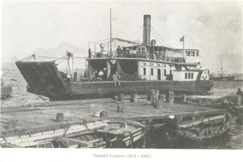 An Old Photo Of A Boat Docked At A Dock With Other Boats In The Water