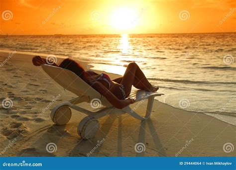 Woman In Chaise Lounge Relaxing On Beach Stock Photo Image Of Ocean Orange
